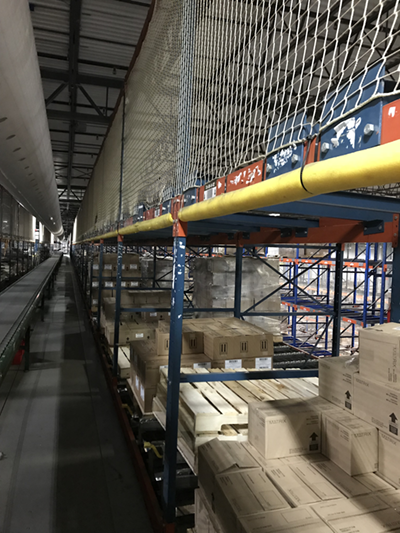 Fall-protection safety netting installed by Industrial Equipment Erectors atop pallet racks
